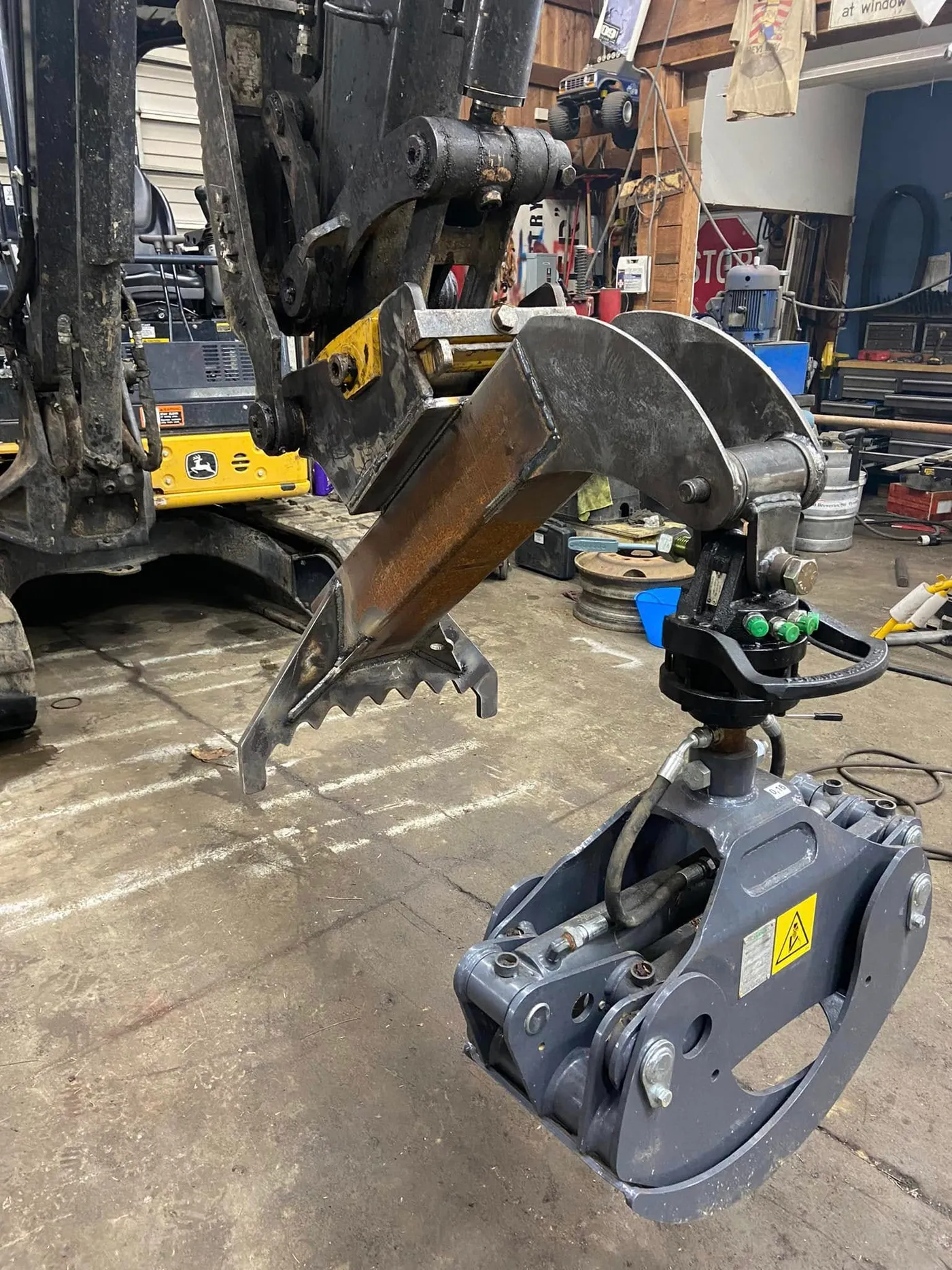 Custom attachment fitted to a John Deere excavator arm