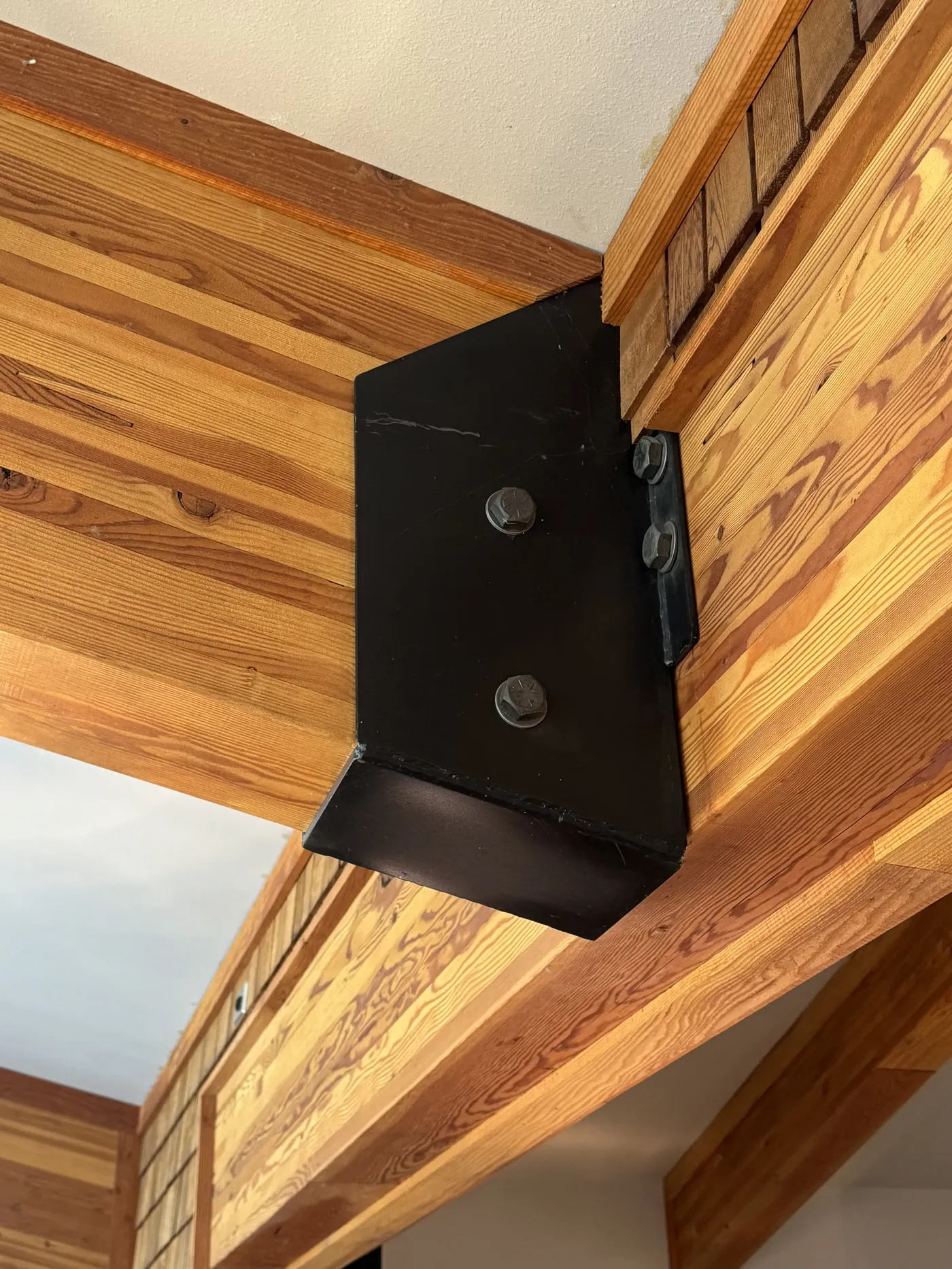 Custom steel bracket welded into a timber frame