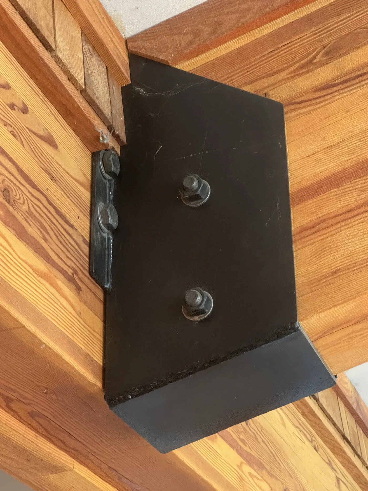 Steel bracket reinforcing a structural timber joint