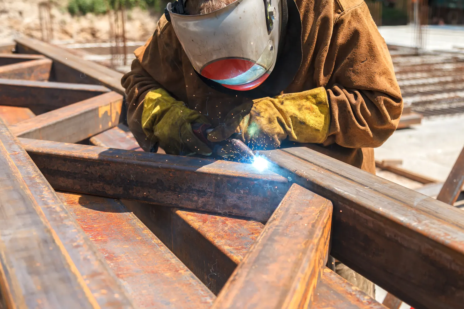 Welder joining a steel structural frame